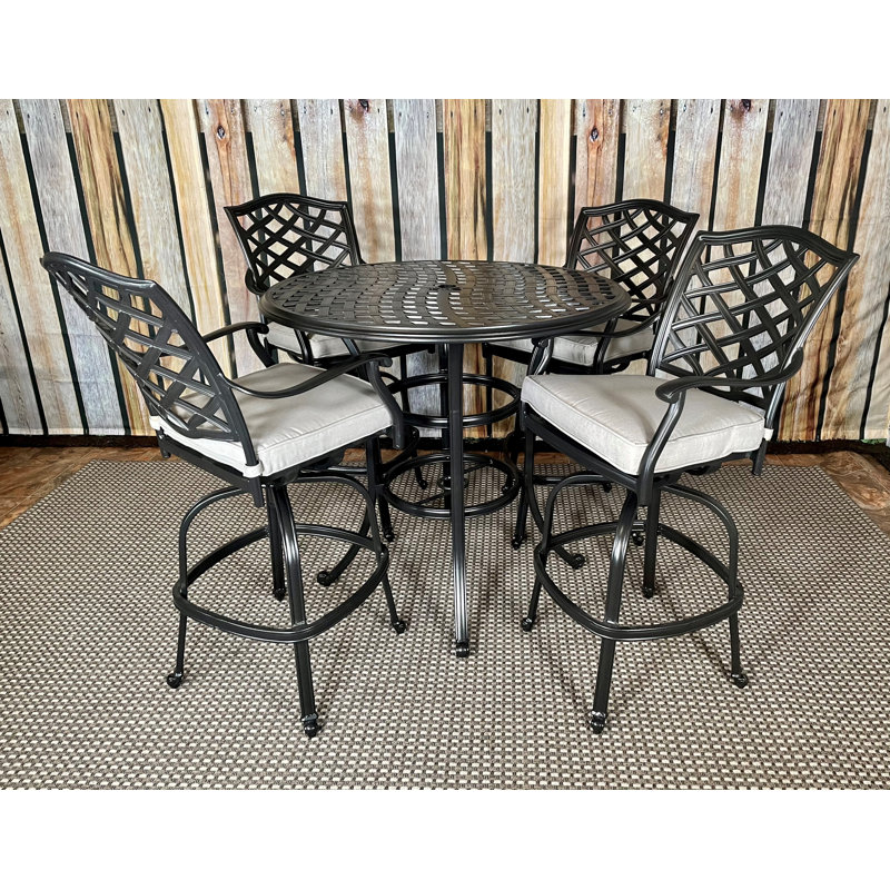 Humza 4 - Person Patio Dining Set with Round Table , Cushions Included