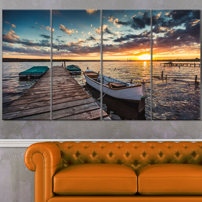 " Boats And Jetty Under Dramatic Sky "