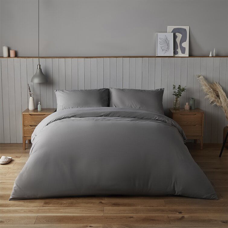 Grey Silentnight Duvet Covet Set that includes pillows, blankets, and sheets in a plain bedroom setting