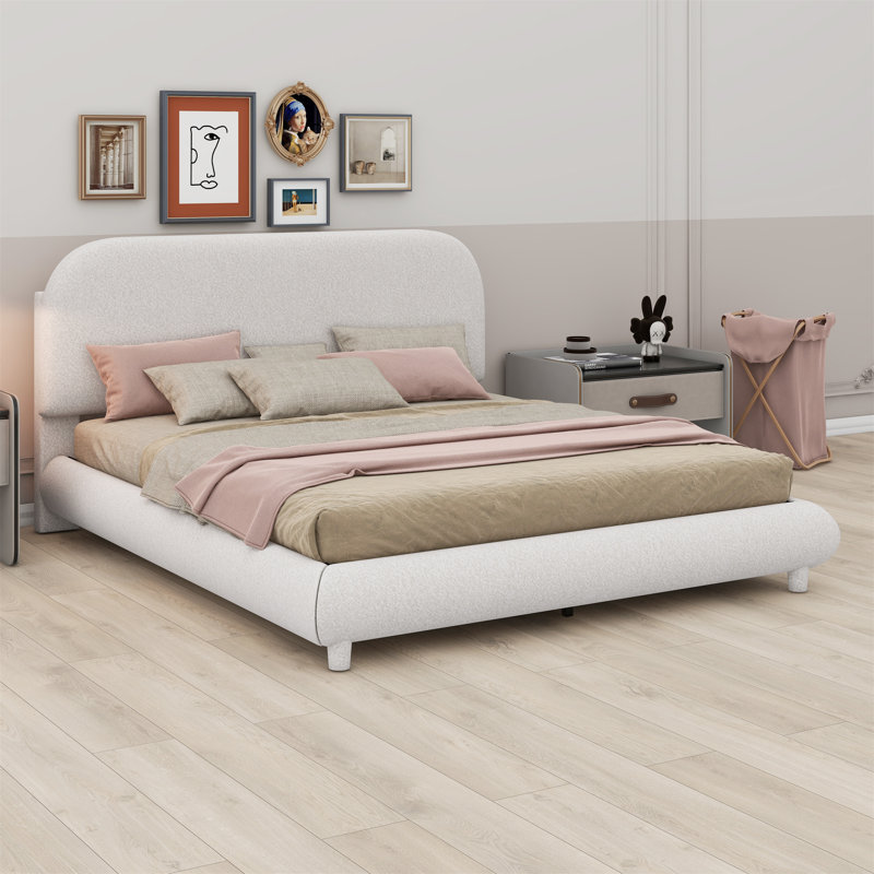 Lit plateforme tapissier avec tissu épais, structure solide et design courbé élégant