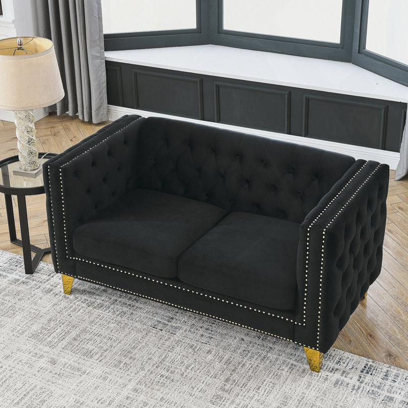 Luxueux canapé rembourré en velours avec accoudoirs carrés capitonnés, idéal pour la détente dans le salon