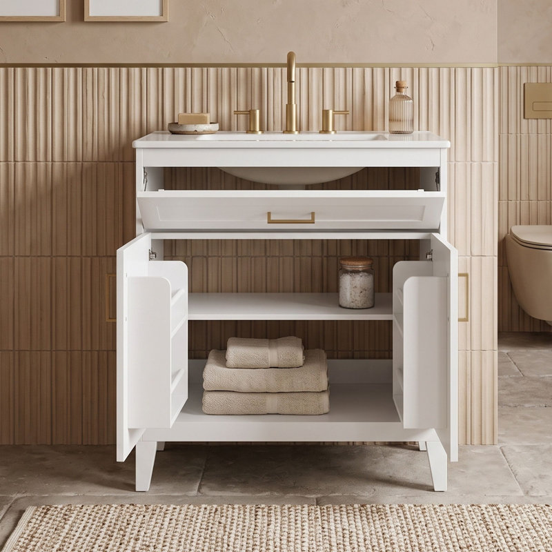 Meuble-lavabo minimaliste sur pied avec lavabo en céramique, tiroir basculant, tablette réglable et portes à fermeture douce.