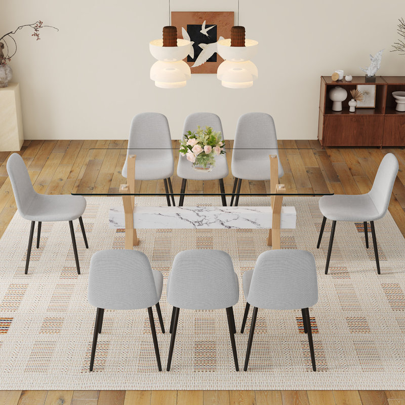 Ensemble de table de salle à manger élégant avec plateau en verre et chaises en lin pour les réunions de famille et les événements sociaux