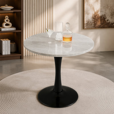 Cette table basse de 27,6 pouces de style Mid-Century moderne peut accueillir de 2 à 4 personnes et est dotée d'un plateau rond en marbre veiné de blanc, qui convient à divers environnements.