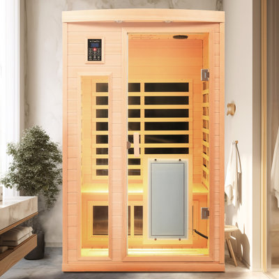 Chambre infrarouge intérieure basse consommation pour deux personnes en bois de pruche, puissance 1750 W, plage de température de 25 à 65 °C, plaque chauffante sur porte vitrée et système audio. 8 panneaux, commandes tactiles, affichage LED.