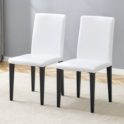 Ensemble de 2 chaises de salle à manger en polyuréthane blanc: hauteur de 35,4 po, dossier ergonomique de 18,5 po, siège en éponge de 17 po x 16 po, parfait pour la salle à manger, le bureau personnel et l'espace de vie, élégant et confortable. Pieds en métal noir.