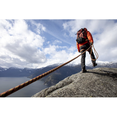 Mountaineer Walks Along Mountain by Ascentxmedia