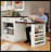 83.1" Extendable Kitchen Island With Slide Out Table, Storage Racks & Power Outlet, Tempered Glass Doors Kitchen Island With Walnut Woodgrain, Cream White