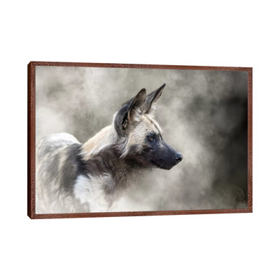 African Wild Dog In The Dust by Susan Schmitz - Print on Canvas