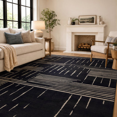 Tapis à rayures géométriques noir et crème, lavable à la machine et doté d'un envers antidérapant