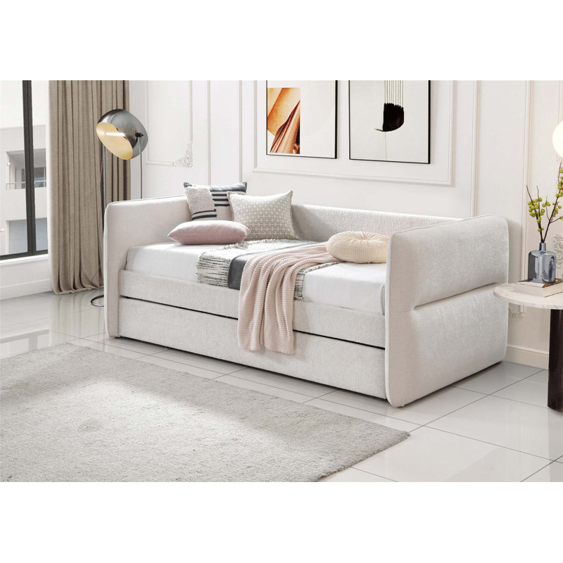Lit de jour moderne avec couchette coulissante, capitonnage à boutons et garniture cloutée pour une utilisation polyvalente dans la chambre à coucher ou le salon.