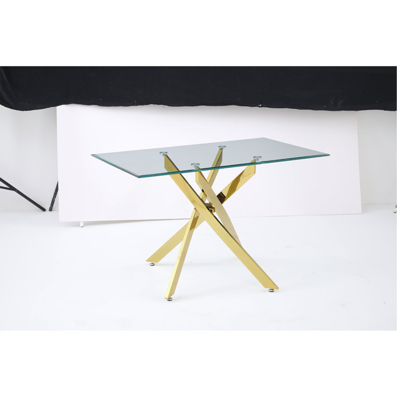 Le plateau de table rectangulaire moderne en verre trempé est associé à un cadre en fer doré, mesurant 47,24 pouces de longueur.