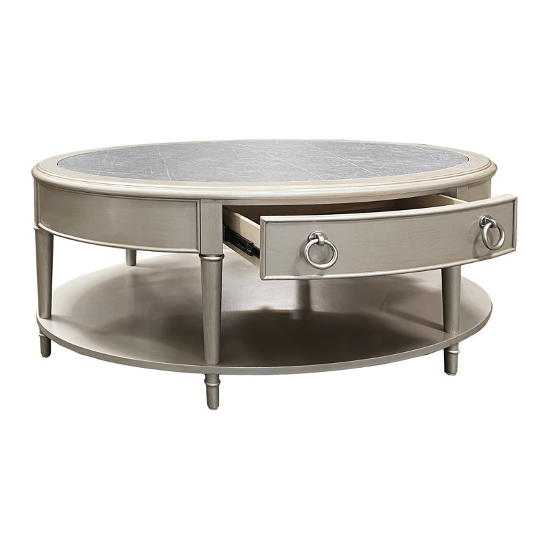 Table basse, pierre frittée et finition champagne