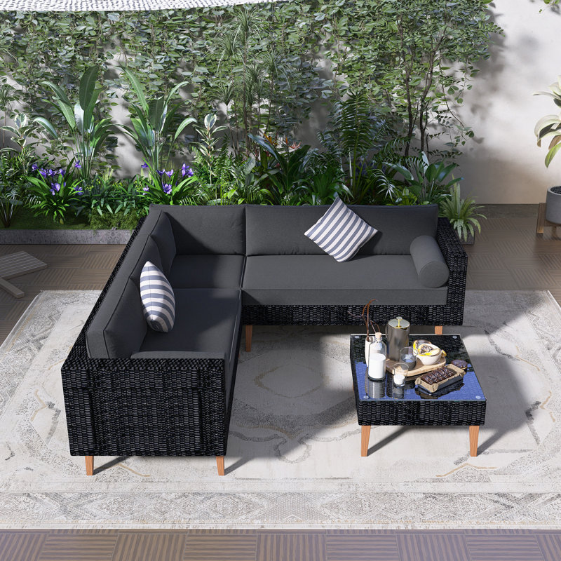 Ensemble de canapé d'extérieur en osier 4 pièces, ensemble de conversation pour patio avec coussins colorés, forme en L, table basse, deux coussins cylindriques, coussins gris et rotin noir