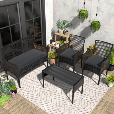 Ensemble de conversation 4 pièces en rotin avec coussins, table basse pour porche, jardin, bord de piscine et jardin