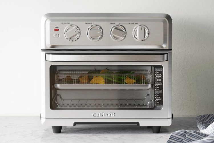 stainless steel toaster oven on a white marble countertop