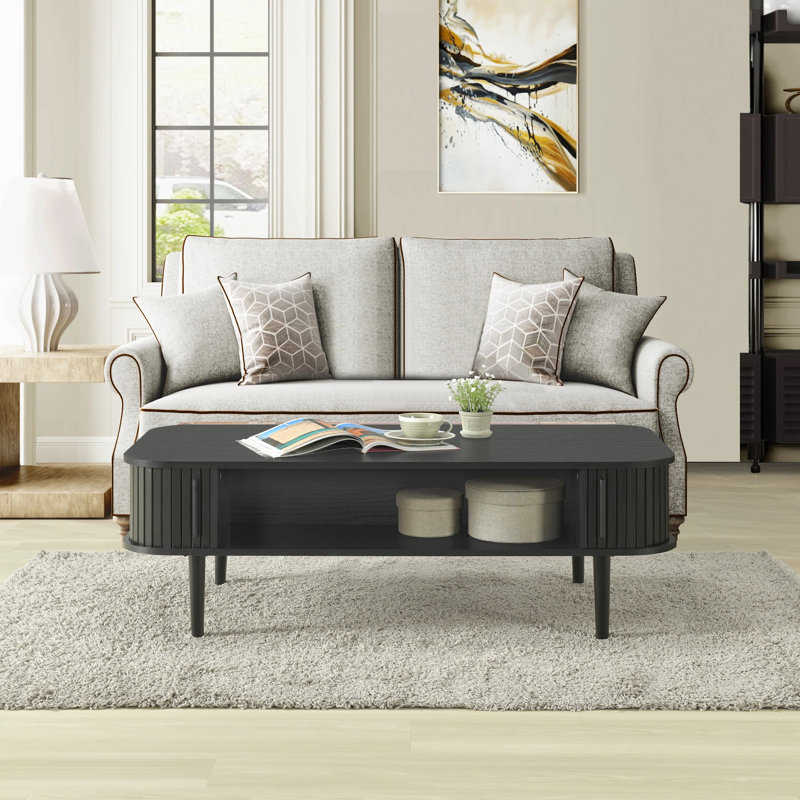 Aguilera 47.2" W Mid Century Coffee Table with Storage and Fluted Sliding Door, Black Oak