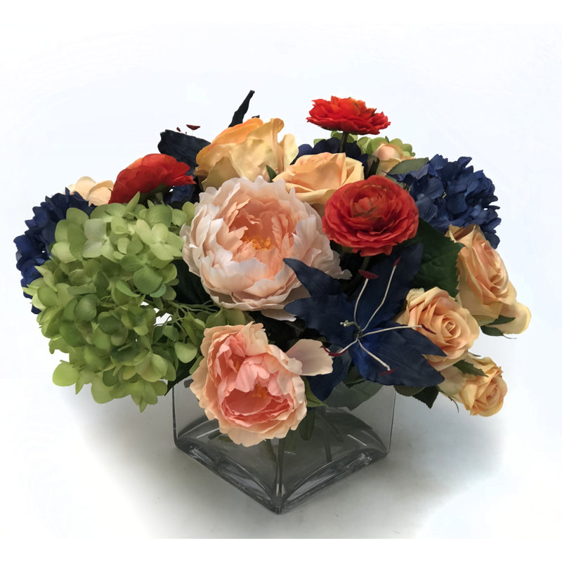 Blue Hydrangea, Lily, Ranunculus And Peach Roses