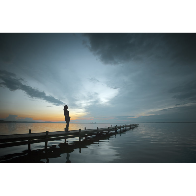 Silhouette of woman on lakeside, 51cm H x 76cm W