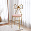 Fauteuil de coiffeuse rose clair à nœud papillon Eluid