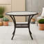 Table d'extérieur en rotin avec plateau et pieds en verre trempé