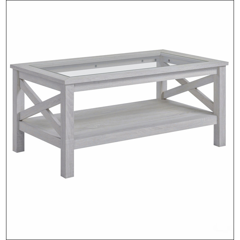 Table basse de style campagnard avec structure en bois, plateau en verre trempé et tablette de rangement en dessous