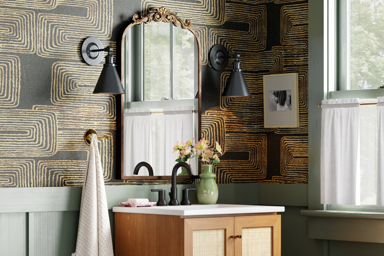 bathroom with black wall sconces, gold vanity mirror, and a wood single vanity