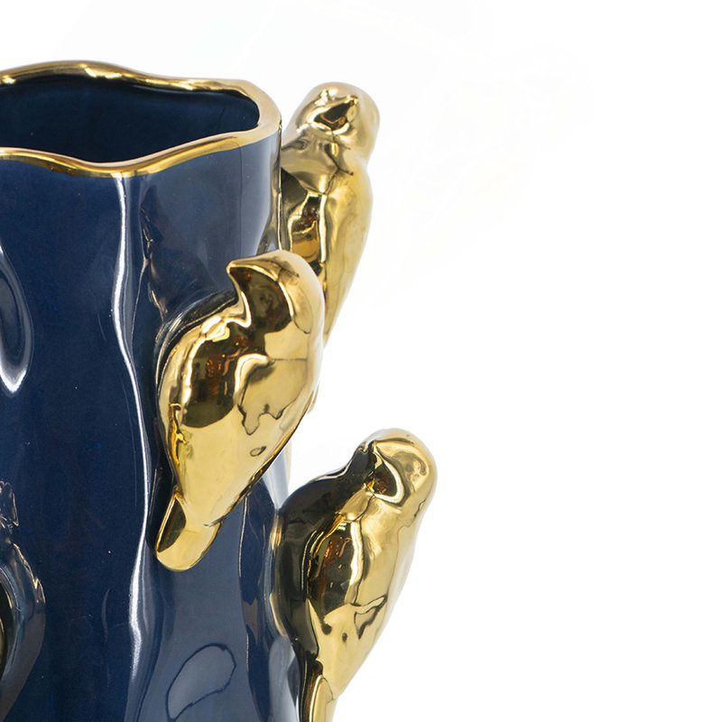 Vase en céramique avec branches d'oiseaux