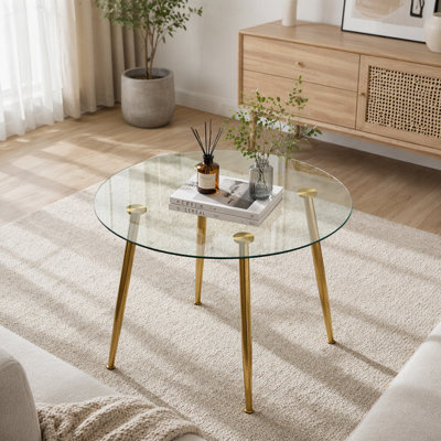 A glass tabletop with a diameter of 40 inches and a modern minimalist circular dining table with electroplated golden metal legs.Suitable for living rooms, and conference rooms.W1151S02857(Table only)