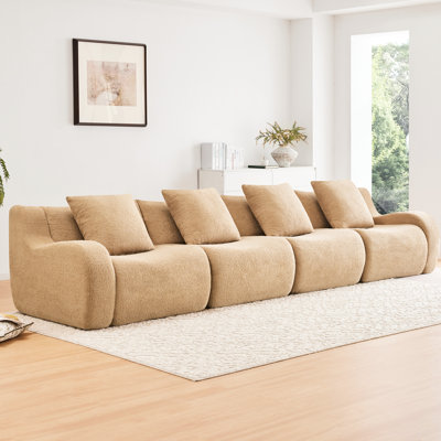 Fauteuil sans os Camel, doté d'un design ergonomique et d'accoudoirs incurvés, avec une base en tissu confortable, conçu pour le salon.