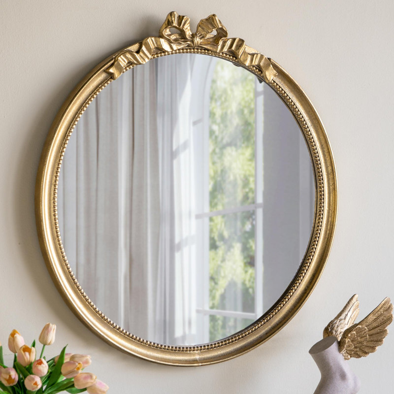 Miroir mural rond avec cadre doré orné