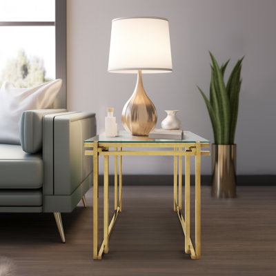 Table d'appoint moderne en verre et en métal avec cadre géométrique épuré