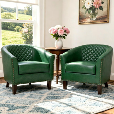 Fauteuil demi-tonneau capitonné avec garniture cloutée Edvardas