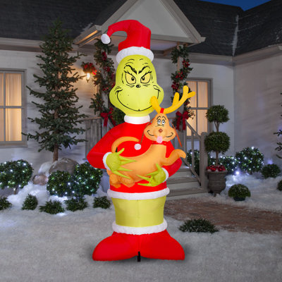 Grinch soufflé à l'air tenant une scène géante du Dr Seuss