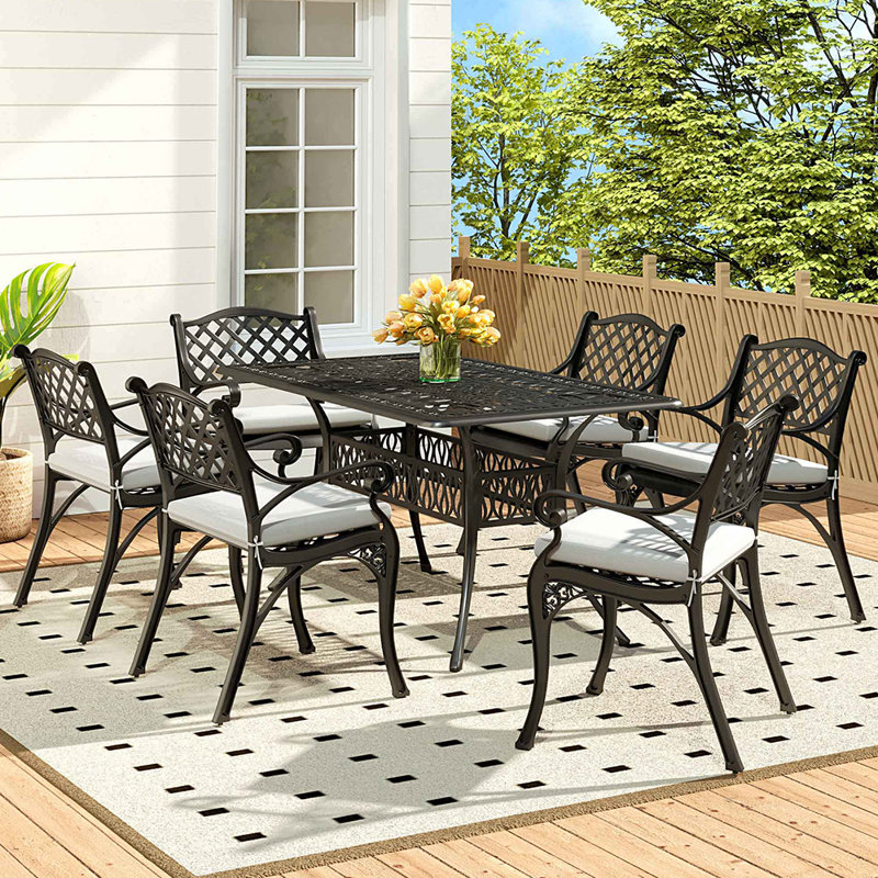 Claudi 6 - Person Patio Dining Set with Rectangular Table , Cushions Included, Black