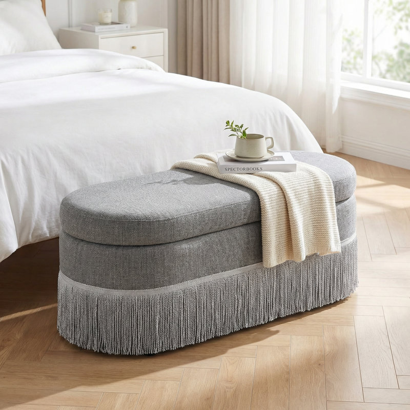 Oval Upholstered Storage Ottoman with Fringe Trim and Lift-Top Lid for Multi-Functional Use in Living Room or Bedroom, Gray