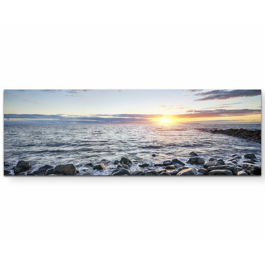 Leinwandbild Steinstrand bei Sonnenuntergang