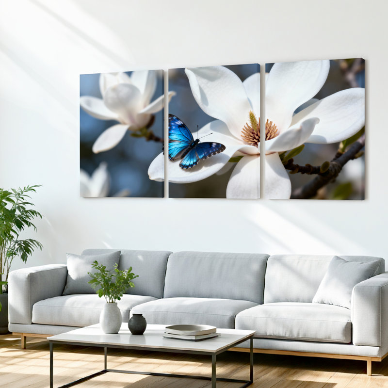 Ensemble de 3 tableaux muraux sur toile tendue représentant un papillon bleu sur une fleur de magnolia blanche