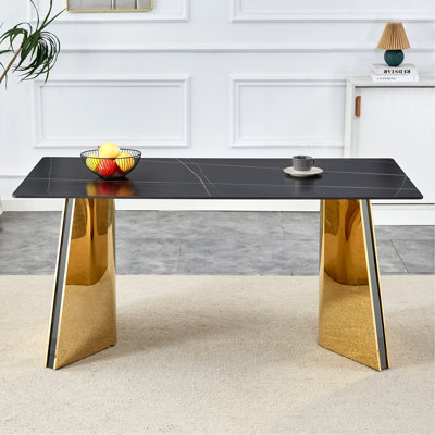 Table de salle à manger de 63 po x 31,5 po x 30 po à motif de marbre noir avec pieds papillon en acier inoxydable doré. Le plateau de table est conçu pour résister aux égratignures et à la chaleur. Plateau de table avec pieds en acier inoxydable doré.