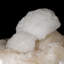 Fleurs centrées de Scolecite sur Stilbite rose