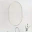 Élégant miroir ovale en métal-117805243-117805241
