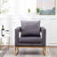 Fauteuil gris contemporain - Style avec assise rembourrée, structure en métal, dossier carré, accoudoirs confortables et revêtement en tissu doux effet velours, pour une détente optimale.