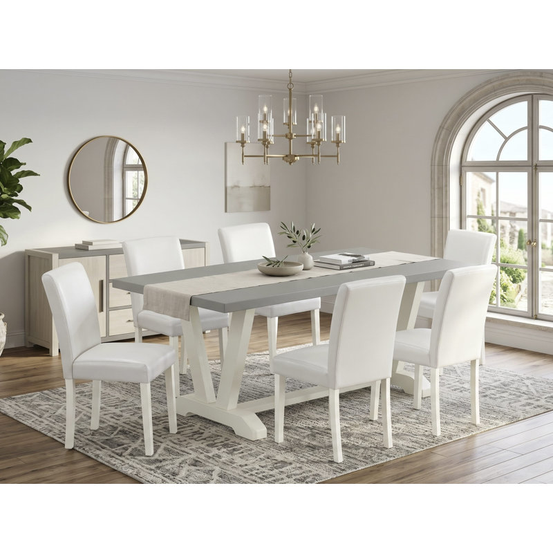 L'ensemble 7 pièces comprend une table rectangulaire en ciment et 6 chaises rembourrées en similicuir blanc - Lin brossé blanc