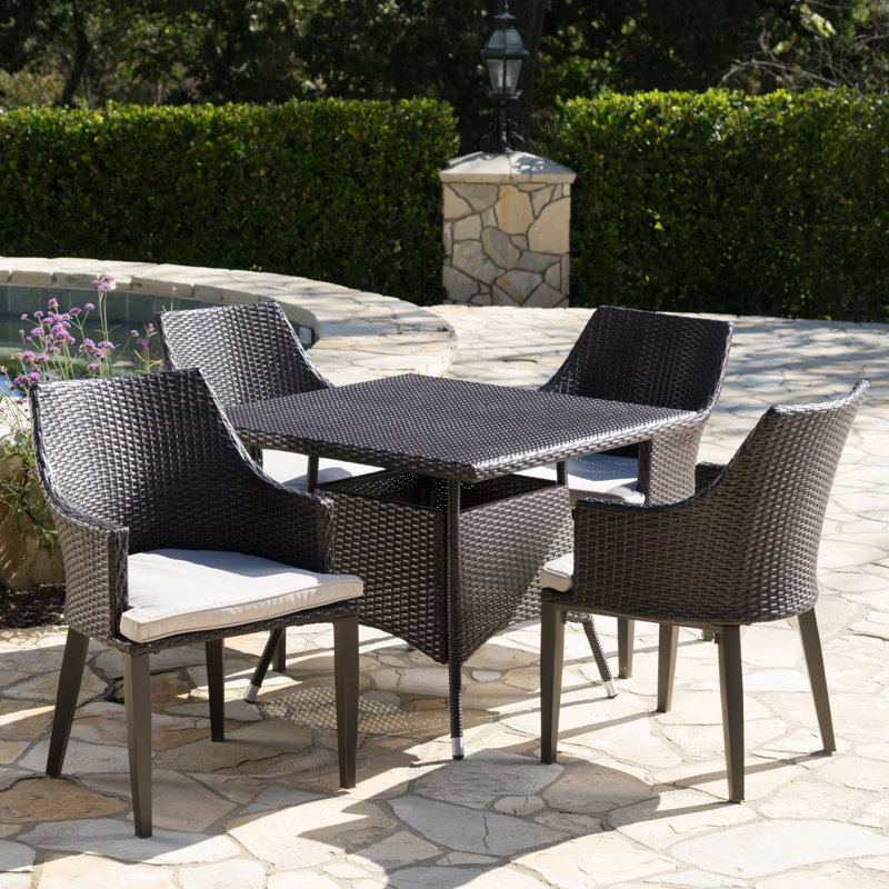 Backlund 4 - Person Wicker Patio Dining Set with Square Table , Cushions Included, Brown