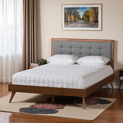 An Emery Mid-Century Modern Platform Bed upholstered in fabric with a walnut brown finish