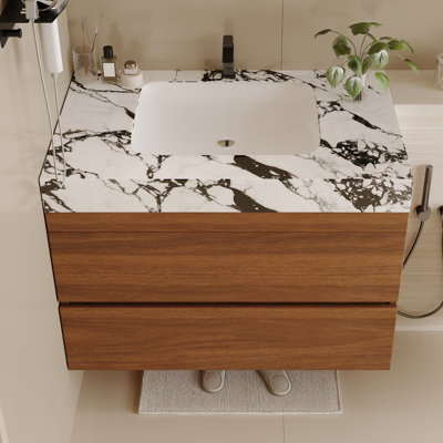 Meuble-lavabo moderne peu encombrant avec lavabo en céramique et comptoir en faux marbre, parfait pour les petites salles de bain