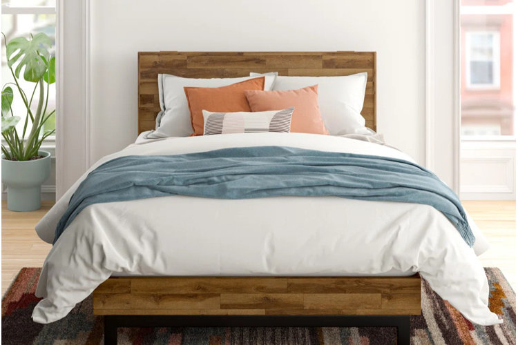 mid-century modern bedroom with a rubberwood bed frame and white bedding