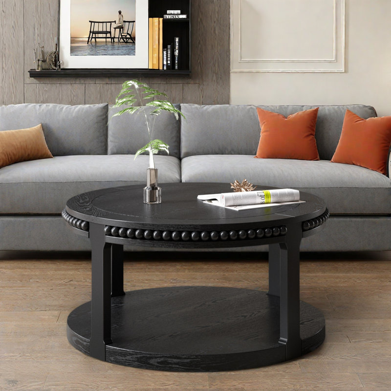 Table basse ronde avec plateau épaissi à deux niveaux, pieds robustes et motif perlé, Noir