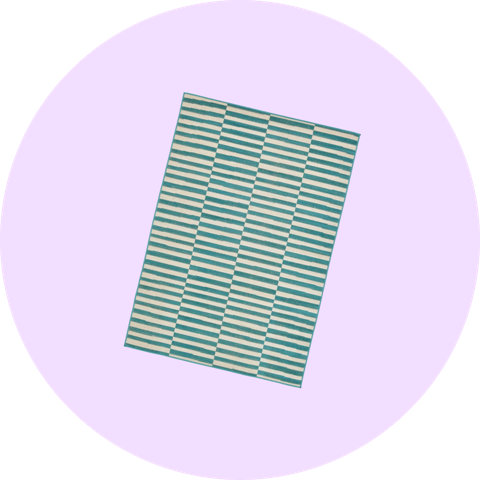 Rectangular area rug with a teal and cream horizontal striped geometric pattern on a light purple circular background.