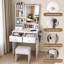  Petit meuble-lavabo moderne avec 3 modes d'éclairage DEL et luminosité réglable, 3 tiroirs et tablettes de rangement ouvertes, support pour sèche-cheveux et prise de courant avec fauteuil, blanc-130141766